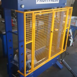 100-ton workshop press with wire protective cage, front doors swing open.