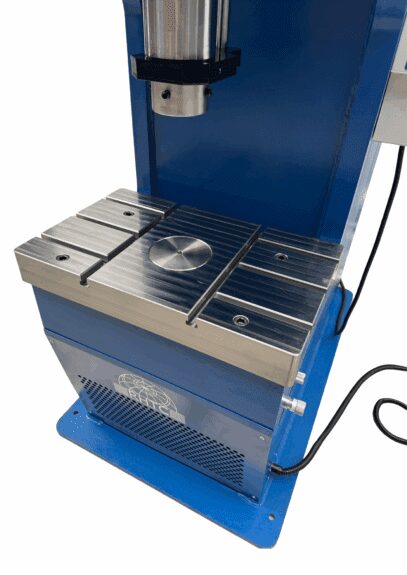 Close-up of PPC-100’s T-slotted work table with central hole for punching applications.